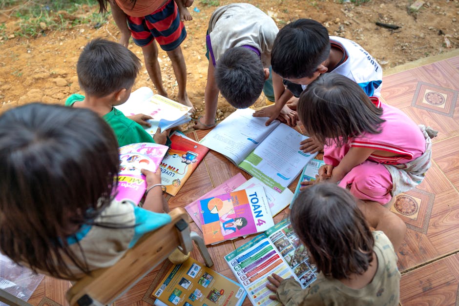 Children gathered outdoors, actively engaged in reading and learning from books