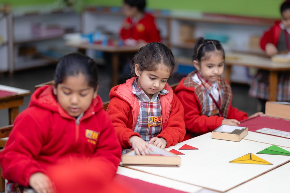 Young children engaged in learning with educational tools in a Montessori classroom setting.