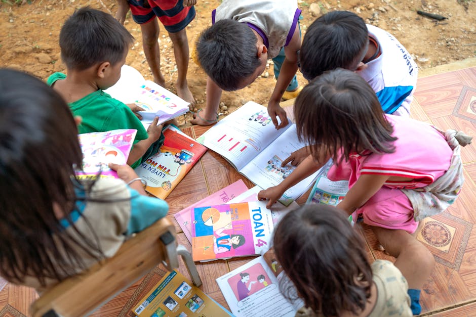 Group of children reading and studying together outdoors.