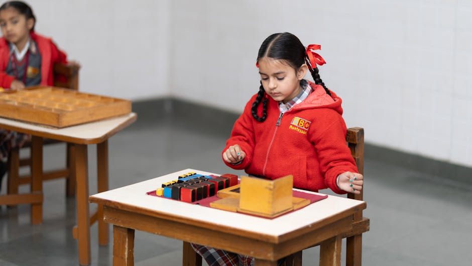 A young girl in a classroom focused on a Montessori educational activity with colorful blocks.